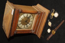 An oak cased mantle clock with Roman numerals to the brushed steel chapter ring with brass dial,