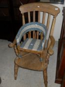 An elm slat back carver chair with turned legs,