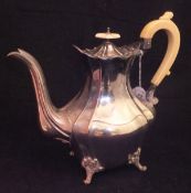A Victorian silver teapot of lozenge shaped form,