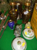 Two Chinese cloisonné vases on a brown round decorated with flower heads,