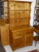 A 20th Century pine dresser with two shelves above two drawers,