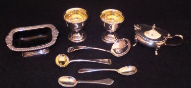 A collection of silver wares comprising a silver salt with blue glass liner,