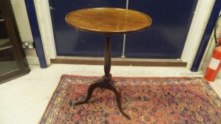 A 20th Century circular mahogany centre table, raised on four legs to claw and ball feet,
