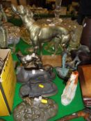 A large brass figure of a hound, three further resin or brass figures of greyhounds/whippets,