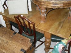 A Victorian pine rectangular extending dining table on turned legs to brown china castors