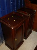 A pair of Victorian mahogany pot cupboards with three quarter galleried top above a single panelled