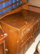 An oak dresser base with two drawers above two cupboard doors to stile feet,