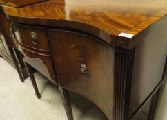 A reproduction mahogany Regency style serpentine fronted sideboard with two central drawers flanked