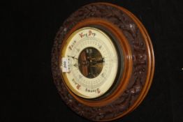 An oak cased aneroid barometer, the dial marked "W Heath & Co.