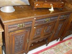 A Victorian walnut sideboard, the plain top above three drawers and four cupboard doors,