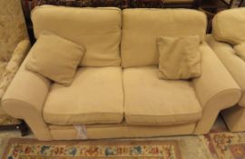 A pair of modern cream upholstered two seat sofas