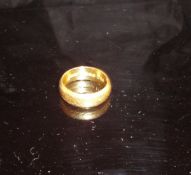 An engraved 22 carat gold wedding band, approx 6.