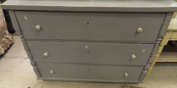 A continental painted pine three drawer commode with white china handles