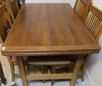 A late 20th Century oak extending draw leaf dining table on moulded square sectioned legs to