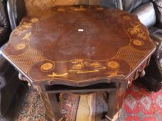 An oriental 20th Century octagonal table with four drawers and open recesses to the top on four