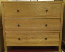 A modern ash three drawer chest and matching open bookshelf of three tiers