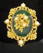 A 9 carat gold mounted pendant / brooch set with central oval jade panel,