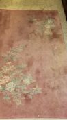 A Chinese superwash carpet, the pink ground set with two floral sprays 154 cm x 91 cm,