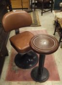 A pair of early to mid 20th Century upholstered swivel chairs on splayed metal bases together with