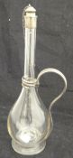 A liqueur decanter with white metal mounts,