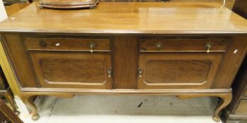 An early 20th Century mahogany sideboard with two drawers above two cupboard doors,