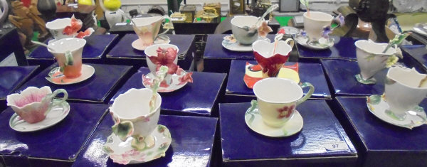 A collection of twelve Franz Porcelain teacups and saucers to include "Summer Bird of Paradise",