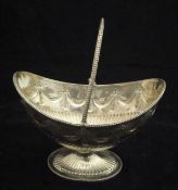 A Victorian silver swing-handled sweetmeat bowl of boat-shaped form,