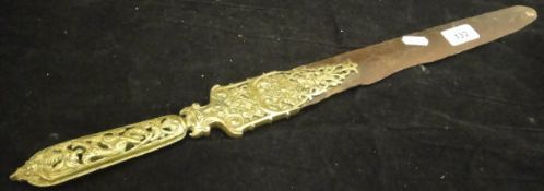 A pierced brass handled Koran turner, carved horn figure of a peacock,