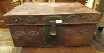 A heavy leather trunk with brass lock plates and stitched lozenge and medallion decoration