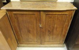 A circa 1900 pitch pine two door cupboard on plinth base