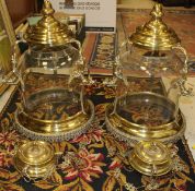 A pair of modern brass and glass pendant ceiling lights in the Empire manner