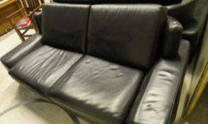 A black leather two seat sofa on chrome legs