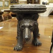 A 20th Century Black Forest type stool in the form of a bear with panel on its back,