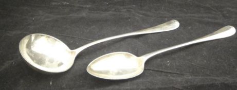 An Edwardian silver serving spoon of "Rat Tail" design (by Walker & Hall, Sheffield, 1905),