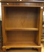 A modern yew wood three tier adjustable open bookcase