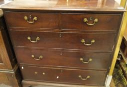 An early 19th Century mahogany chest of two short over three long graduated drawers with brass swan