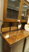 A 19th Century mahogany dresser with two glazed doors enclosing shelves above a mirrored back,