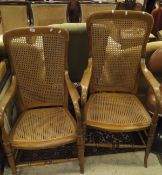 A pair of Victorian caned open arm elbow chairs on turned legs united by stretchers (1 with legs