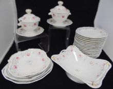 A Bloor Derby rose and gilt decorated part dinner service comprising fifteen plates,