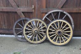 A pair of painted cart wheels,