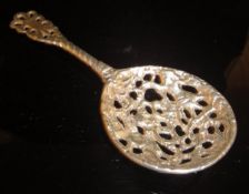 A Victorian cast silver sifter spoon with putti decoration to bowl (by Cornelius Desormeaux