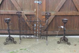 A pair of wrought iron ale warmers with floral decoration,