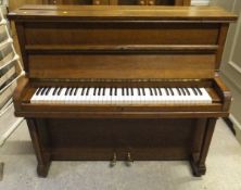 An oak cased upright piano,