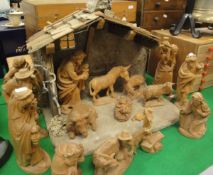 A 20th Century carved wood Nativity scene with sixteen various figures and stable