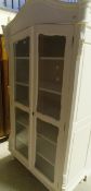 A white painted two door glazed bookcase cabinet in the 19th Century French style