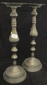 A pair of large pricket candlesticks with patinated brassed finish