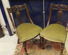 A set of six Victorian mahogany framed dining chairs with swept backs and green velvet plush