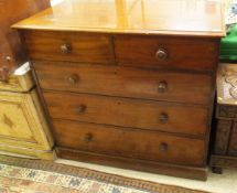 A Victorian mahogany chest of two short and three long drawers with turned wood handles to plinth