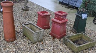 A set of three painted chimney pots, together with another similar,