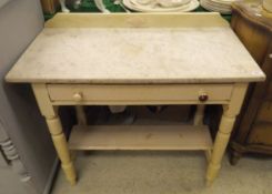 A white marble topped wash stand with single drawer on turned legs united under tier